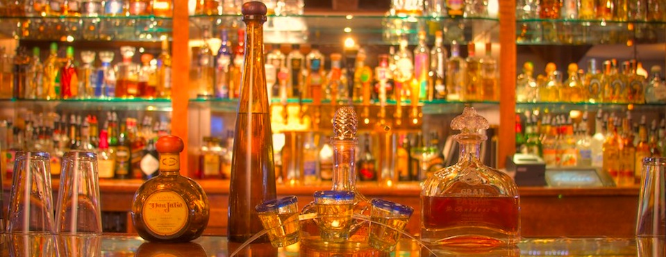 A photo of tequila on a bar.